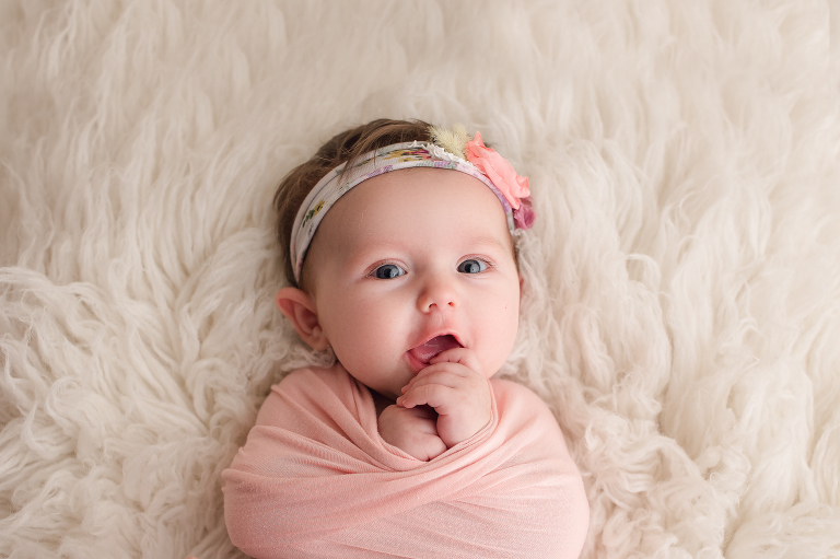 baby girl in pink wrap and headband